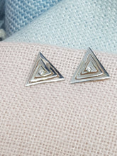 Sterling silver cut out triangle drop earrings set with a clear cubic zirconia