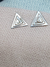 Sterling silver cut out triangle drop earrings set with a clear cubic zirconia