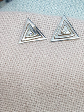 Sterling silver cut out triangle drop earrings set with a clear cubic zirconia