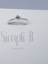 Sterling silver ring with a red cubic zirconia set in a cube