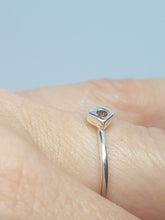 Sterling silver ring with a red cubic zirconia set in a cube