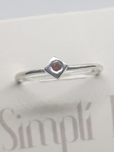 Sterling silver ring with a red cubic zirconia set in a cube