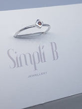 Sterling silver ring with a red cubic zirconia set in a cube