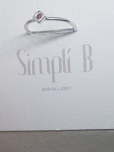 Sterling silver ring with a red cubic zirconia set in a cube